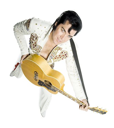 silhouette people performing - Portrait généraux d'un imitateur d'Elvis tenant une guitare Photographie de stock - Premium Libres de Droits, Code: 640-02767614