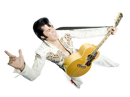 silhouette people performing - Portrait généraux d'un imitateur d'Elvis tenant une guitare Photographie de stock - Premium Libres de Droits, Code: 640-02767616