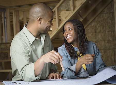 Young couple discussing a blueprint Stock Photo - Premium Royalty-Free, Code: 640-02767677