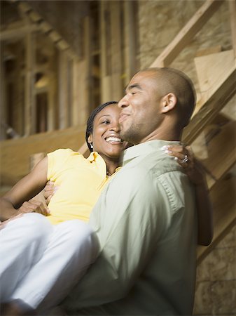 Close-up of a young man carrying a young woman and smiling Stock Photo - Premium Royalty-Free, Code: 640-02767696