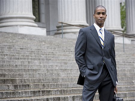 simsearch:640-02767805,k - Portrait of a male lawyer standing on the steps of a courthouse and smiling Stock Photo - Premium Royalty-Free, Code: 640-02767786