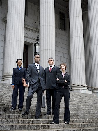 simsearch:640-02767805,k - Low angle view of lawyers standing on the steps of a courthouse Stock Photo - Premium Royalty-Free, Code: 640-02767788