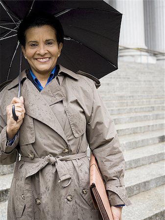 simsearch:640-02767805,k - Low angle view of a woman holding an umbrella and smiling Stock Photo - Premium Royalty-Free, Code: 640-02767781