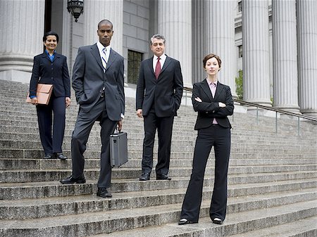 simsearch:640-02767805,k - Low angle view of lawyers standing on the steps of a courthouse Stock Photo - Premium Royalty-Free, Code: 640-02767790