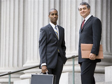 simsearch:640-02767805,k - Low angle view of two men smiling and standing in front of a courthouse Stock Photo - Premium Royalty-Free, Code: 640-02767800