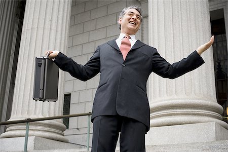 simsearch:640-02767805,k - Low angle view of a male lawyer holding a briefcase and laughing Stock Photo - Premium Royalty-Free, Code: 640-02767817