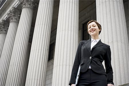 simsearch:640-02767805,k - Low angle view of a female lawyer standing in front of a courthouse Stock Photo - Premium Royalty-Free, Code: 640-02767810