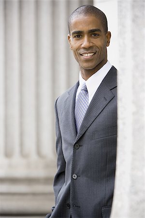 simsearch:640-02767805,k - Portrait of a male lawyer standing in front of a courthouse and smiling Stock Photo - Premium Royalty-Free, Code: 640-02767824