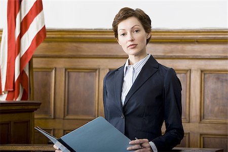 simsearch:640-02767805,k - Portrait of a female lawyer standing in a courtroom and smiling Stock Photo - Premium Royalty-Free, Code: 640-02767845