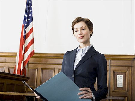 simsearch:640-02767805,k - Portrait of a female lawyer standing in a courtroom and smiling Stock Photo - Premium Royalty-Free, Code: 640-02767843