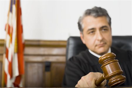 simsearch:640-01351636,k - A male judge hitting a gavel on the bench Stock Photo - Premium Royalty-Free, Code: 640-02767895