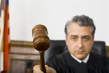 simsearch:640-01351636,k - A male judge hitting a gavel on the bench Stock Photo - Premium Royalty-Free, Code: 640-02767896