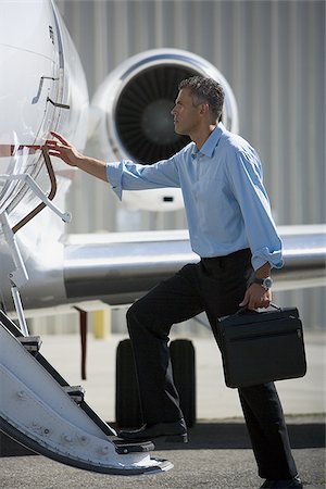 simsearch:640-01350298,k - Profile of a businessman entering an airplane Stock Photo - Premium Royalty-Free, Code: 640-02767923