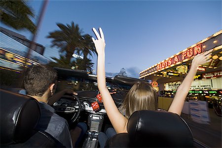 Rear view of a young couple sitting in a car Stock Photo - Premium Royalty-Free, Code: 640-02768027