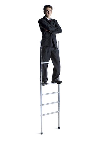 Businessman standing on corporate ladder Stock Photo - Premium Royalty-Free, Code: 640-02768453