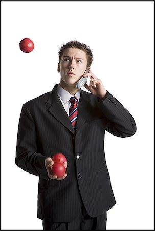 simsearch:640-03260747,k - Businessman juggling while talking on phone Stock Photo - Premium Royalty-Free, Code: 640-02768463