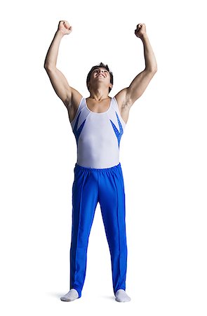 Male gymnast doing floor exercises Stock Photo - Premium Royalty-Free, Code: 640-02768476