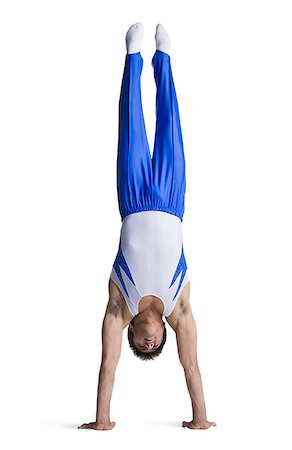 Male gymnast doing floor exercises Stock Photo - Premium Royalty-Free, Code: 640-02768471