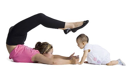 silhouette of woman bending backwards - Contortionist mother with baby daughter Stock Photo - Premium Royalty-Free, Code: 640-02768487