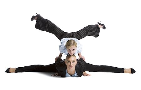 Two female contortionist businesswomen Stock Photo - Premium Royalty-Free, Code: 640-02768630