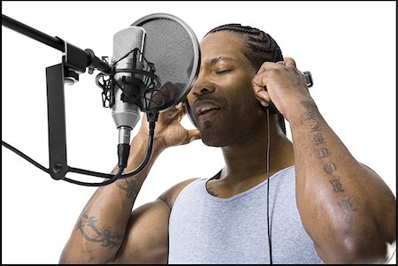 African American man singing into microphone Stock Photo - Premium Royalty-Free, Code: 640-02768889