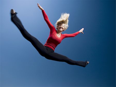 Woman jumping Stock Photo - Premium Royalty-Free, Code: 640-02769285