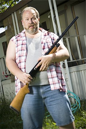 simsearch:640-02769450,k - Overweight man with a shotgun Stock Photo - Premium Royalty-Free, Code: 640-02769447