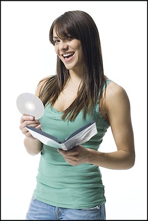 dvd silhouette - Young woman holding a DVD Stock Photo - Premium Royalty-Free, Code: 640-02769577