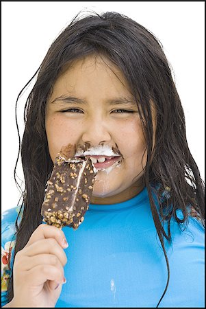 Overweight young girl eating ice cream bar Stock Photo - Premium Royalty-Free, Code: 640-02769666