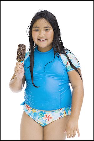 Overweight young girl eating ice cream bar Stock Photo - Premium Royalty-Free, Code: 640-02769661