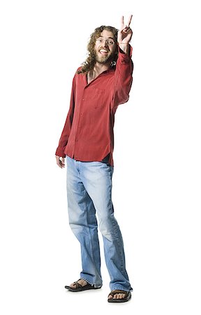 Man with long hair and beard making peace gesture Stock Photo - Premium Royalty-Free, Code: 640-02769806