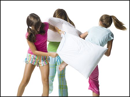 pajamas teenage - Three girls pillow fighting Stock Photo - Premium Royalty-Free, Code: 640-02769841