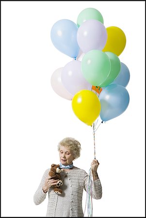 Older woman holding balloons Foto de stock - Sin royalties Premium, Código: 640-02769996