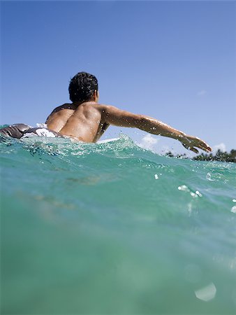 Man lying on surfboard in water Stock Photo - Premium Royalty-Free, Code: 640-02774122