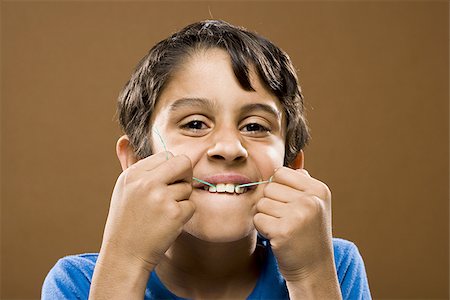 dental floss - Closeup of boy flossing teeth Stock Photo - Premium Royalty-Free, Code: 640-02774370