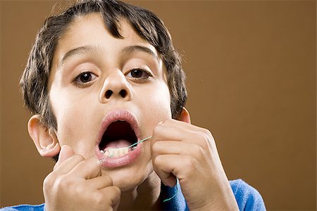 dental floss - Closeup of boy flossing teeth Stock Photo - Premium Royalty-Free, Code: 640-02774372