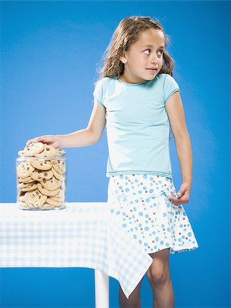 sneak - Girl sneaking Chocolate Chip Cookie from cookie jar Stock Photo - Premium Royalty-Free, Code: 640-02774391