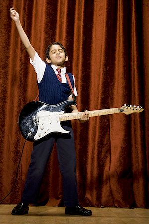 stage play curtain - Boy on stage playing electric guitar Stock Photo - Premium Royalty-Free, Code: 640-02774485