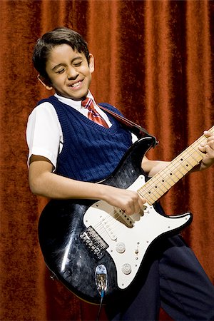 stage play curtain - Boy on stage playing electric guitar Stock Photo - Premium Royalty-Free, Code: 640-02774482