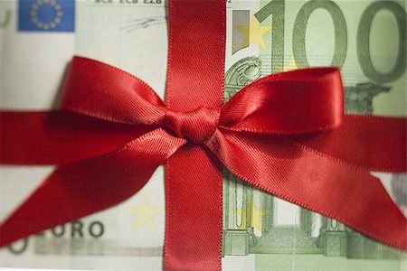 One hundred Euro banknote with red ribbon closeup Stock Photo - Premium Royalty-Free, Code: 640-02774592