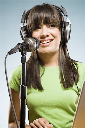 podcast - Woman with headphones and laptop singing into microphone Stock Photo - Premium Royalty-Free, Code: 640-02775247