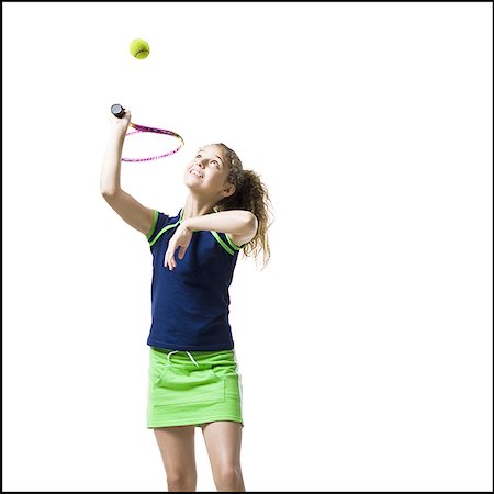 Girl holding tennis racquet and serving Stock Photo - Premium Royalty-Free, Code: 640-02775363