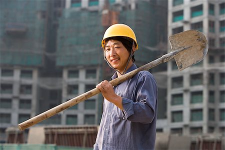 shovel (hand tool for digging) - Construction worker outdoors with helmet smiling Stock Photo - Premium Royalty-Free, Code: 640-02775495