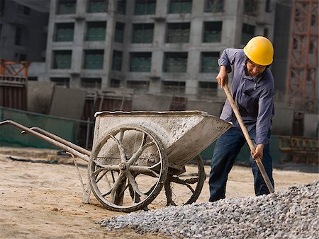 shovel (hand tool for digging) - Construction worker outdoors with helmet smiling Stock Photo - Premium Royalty-Free, Code: 640-02775491