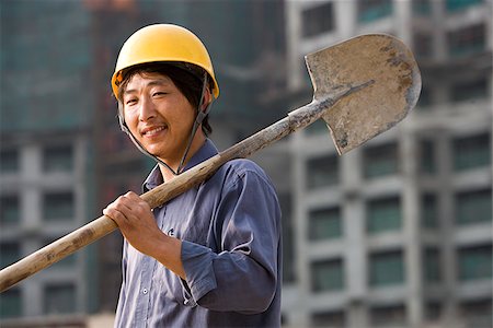 shovel (hand tool for digging) - Construction worker outdoors with helmet smiling Stock Photo - Premium Royalty-Free, Code: 640-02775493