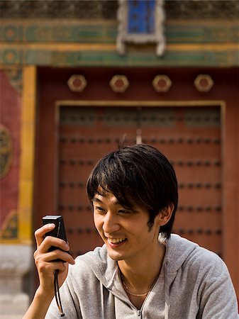 simsearch:640-03260747,k - Teenage boy outdoors with cell phone smiling Stock Photo - Premium Royalty-Free, Code: 640-02775503
