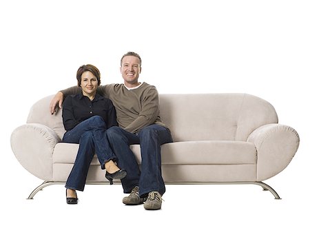 Couple sitting on a couch. Stock Photo - Premium Royalty-Free, Code: 640-02775995