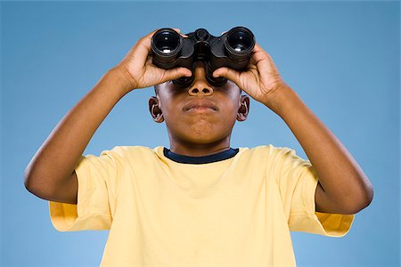 Child looking through binoculars. Stock Photo - Premium Royalty-Free, Code: 640-02776114