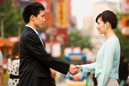 Man and a woman shaking hands. Stock Photo - Premium Royalty-Free, Code: 640-02776182