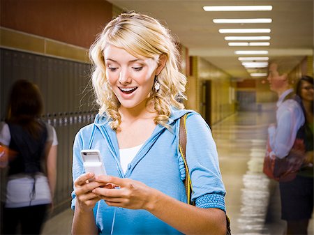 High School girl at school text messaging. Stock Photo - Premium Royalty-Free, Code: 640-02776405